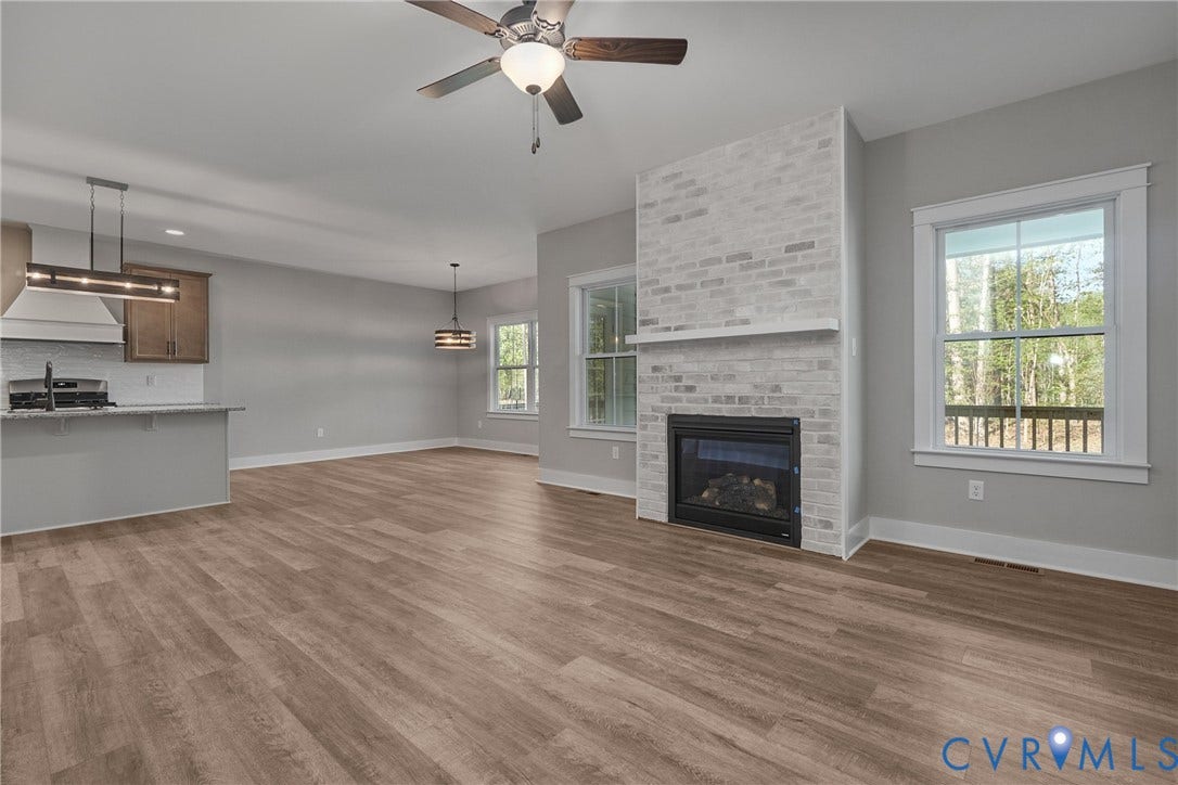 11121 Somerset Hill Drive, Somerset Hills, Glen Allen, VA 23059 Wood-finish flooring throughout, with a white brick fireplace featuring a black firebox