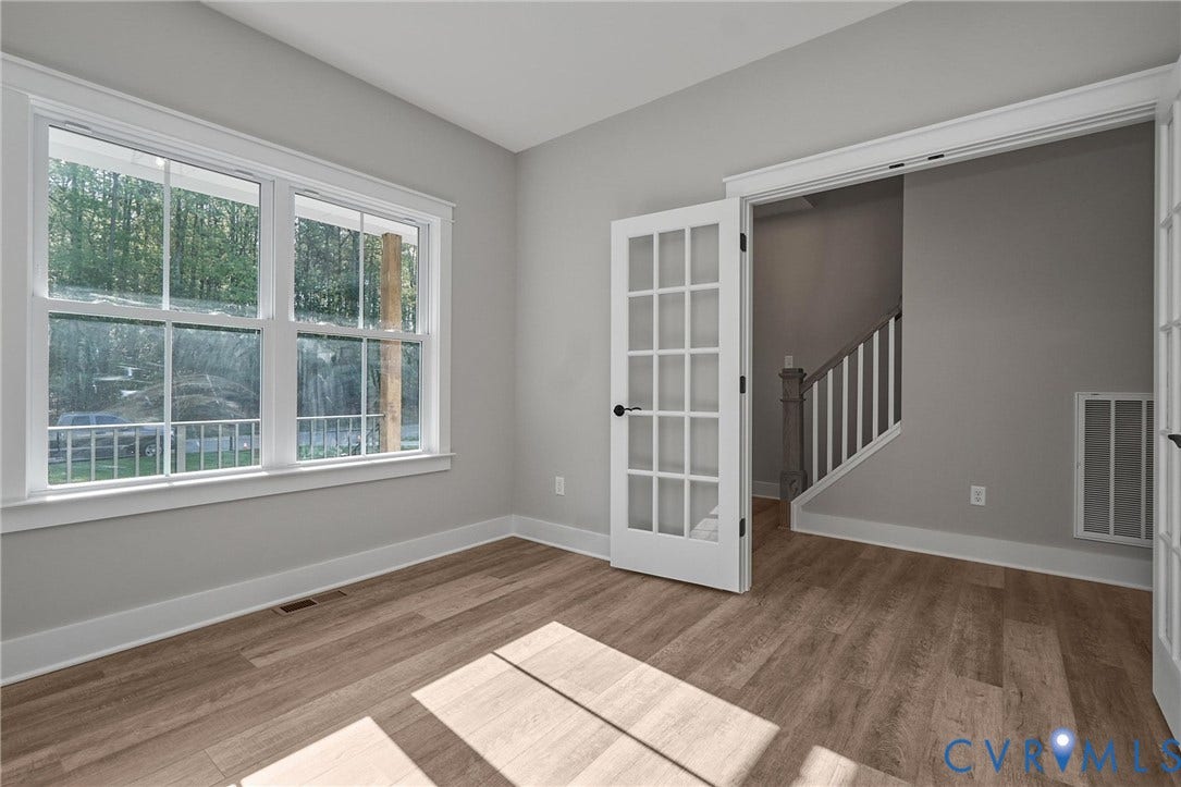 11121 Somerset Hill Drive, Somerset Hills, Glen Allen, VA 23059 Light wood-finish flooring, white trim, dual French doors, large double-hung windows, and a staircase with white spindles