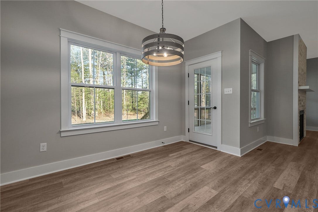 11121 Somerset Hill Drive, Somerset Hills, Glen Allen, VA 23059 Wood-finish flooring with a multi-pane window, a glass-paneled door, and a modern drum light fixture