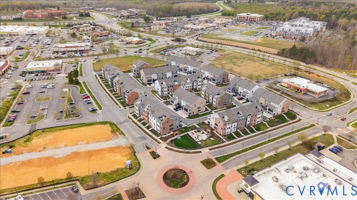412 Quiet Breeze Alley, Chesterfield, VA 23113 Townhome community with brick and siding exteriors, surrounded by commercial developments and open land
