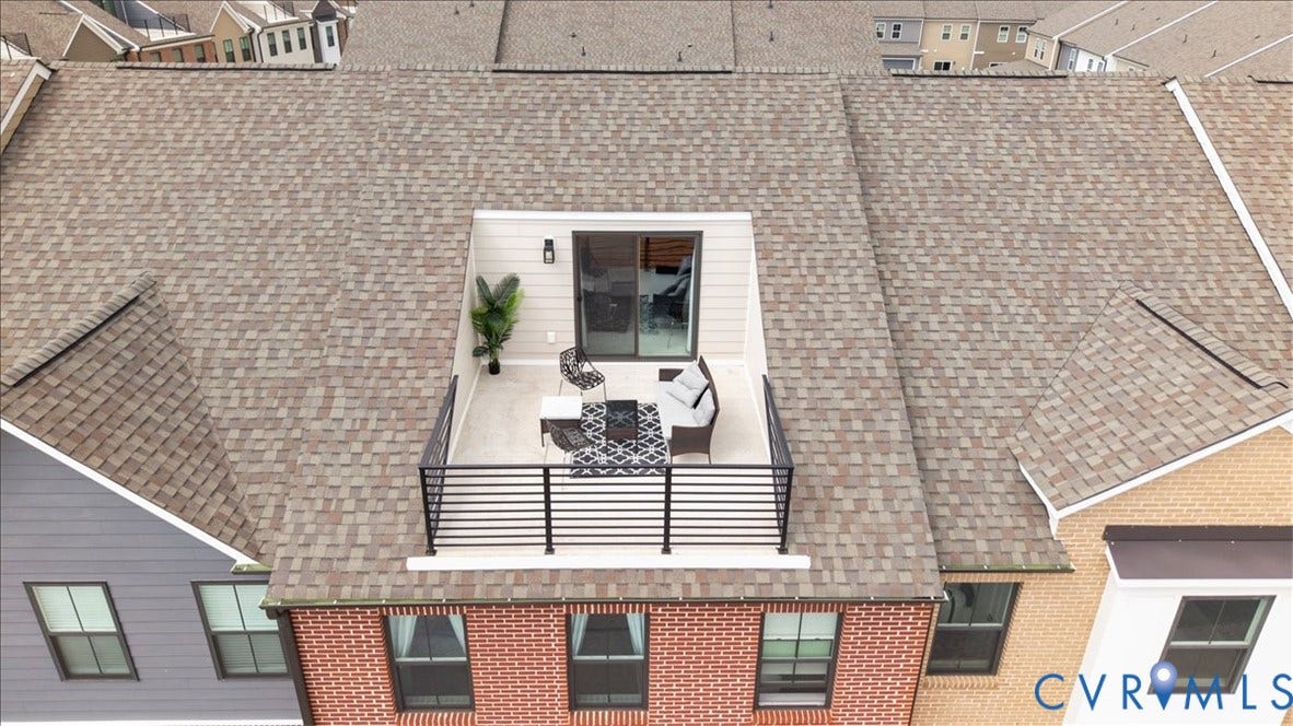 412 Quiet Breeze Alley, Chesterfield, VA 23113 Rooftop terrace with black metal railings, a sliding glass door entry, and wall-mounted exterior lighting