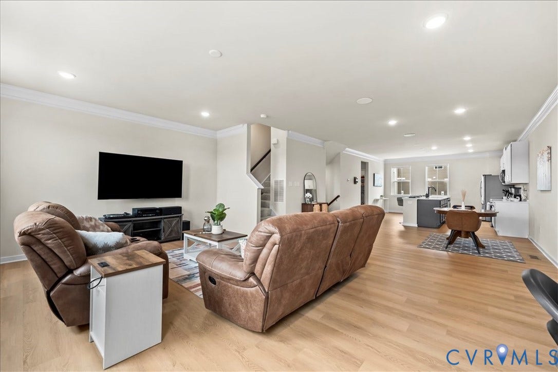 412 Quiet Breeze Alley, Chesterfield, VA 23113 Recessed lighting, crown molding, wood-finish flooring, staircase with white risers, and a kitchen featuring white cabinetry and an island