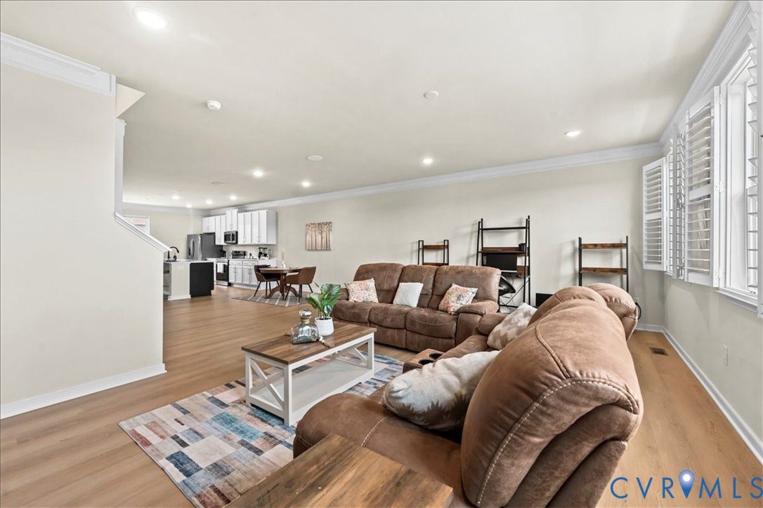 412 Quiet Breeze Alley, Chesterfield, VA 23113 Expansive open-concept living area featuring wood-finish flooring, recessed lighting, and crown molding
