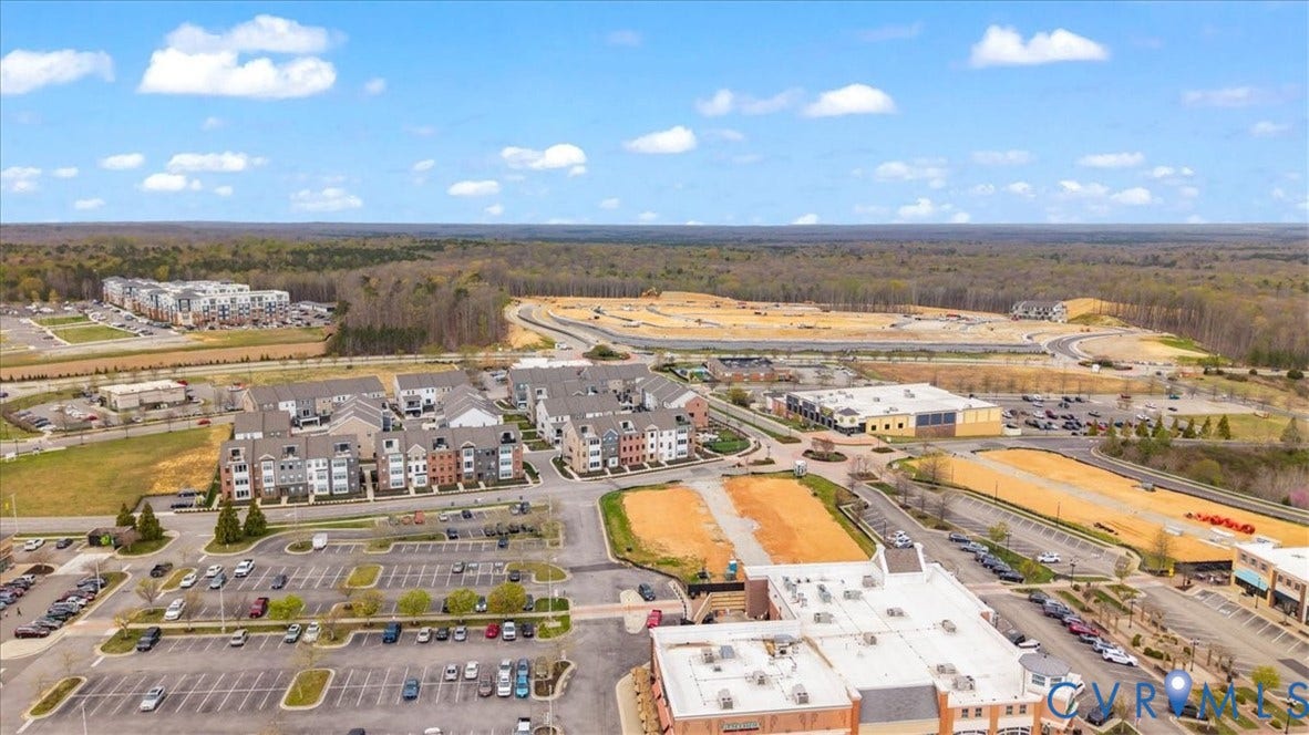 412 Quiet Breeze Alley, Chesterfield, VA 23113 Urban development featuring residential townhomes, commercial structures, and expansive undeveloped parcels