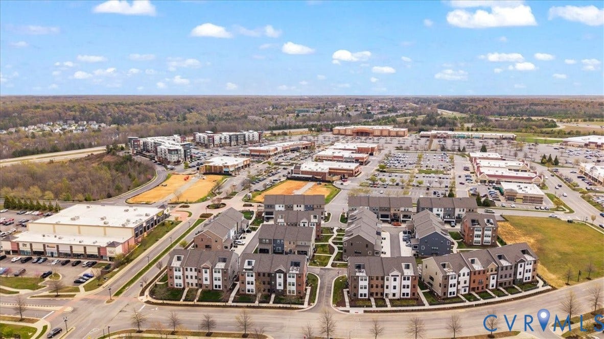 412 Quiet Breeze Alley, Chesterfield, VA 23113 Aerial perspective showcasing a community of multi-story residential buildings, commercial structures, and extensive parking areas