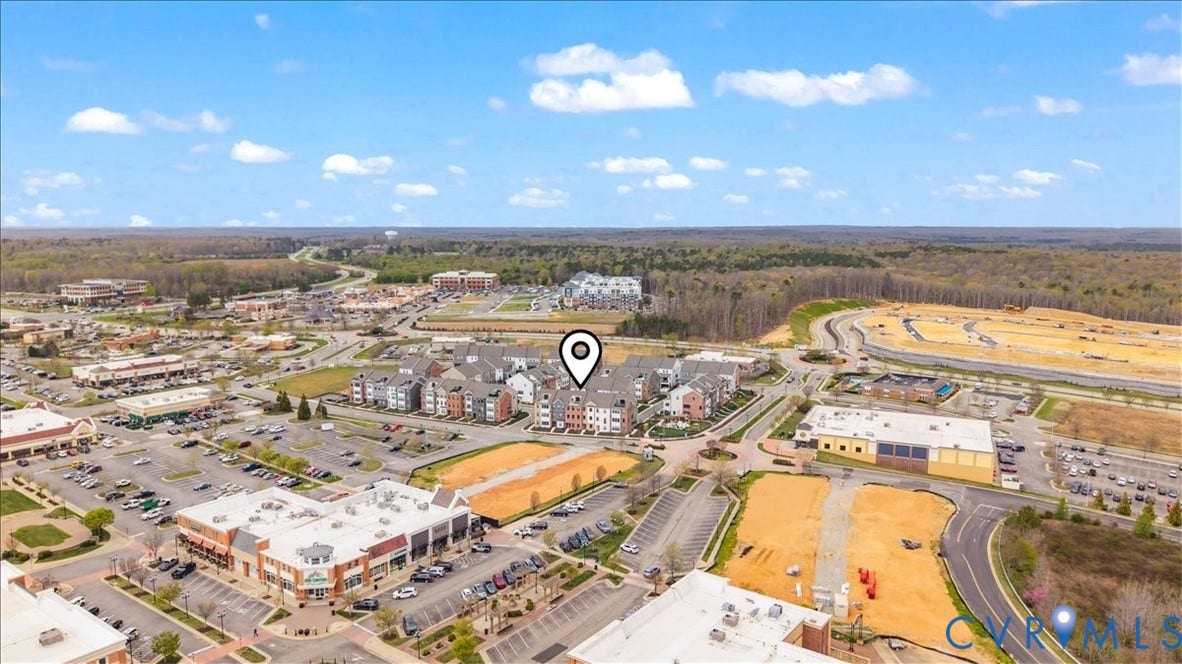 412 Quiet Breeze Alley, Chesterfield, VA 23113 Aerial perspective of a developed commercial area with multiple retail buildings, extensive parking facilities, and multi-story residential structures