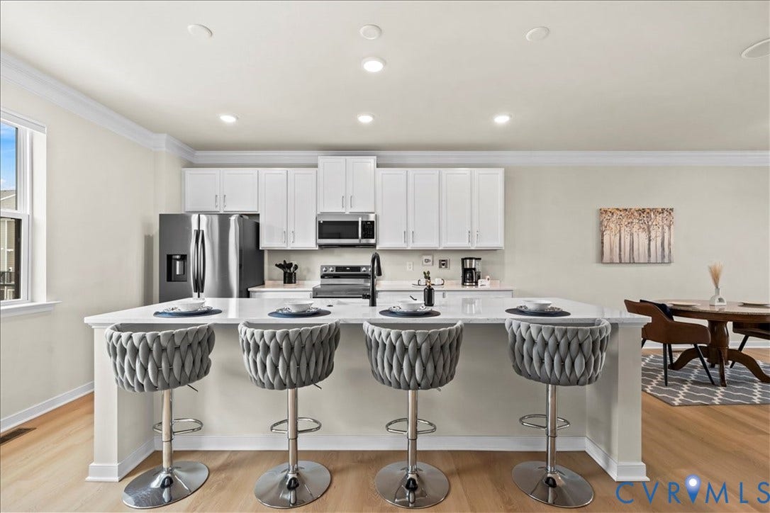 412 Quiet Breeze Alley, Chesterfield, VA 23113 Kitchen island with seating, white cabinetry, stainless steel appliances, and recessed lighting