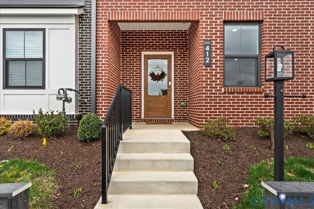 412 Quiet Breeze Alley, Chesterfield, VA 23113 Brick facade with a contrasting white-paneled section