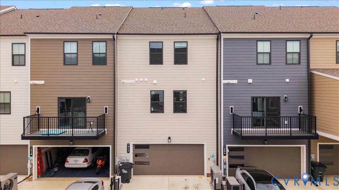 412 Quiet Breeze Alley, Chesterfield, VA 23113 Two-story townhome with a dark brown shingle roof, light beige horizontal siding, and black-framed windows