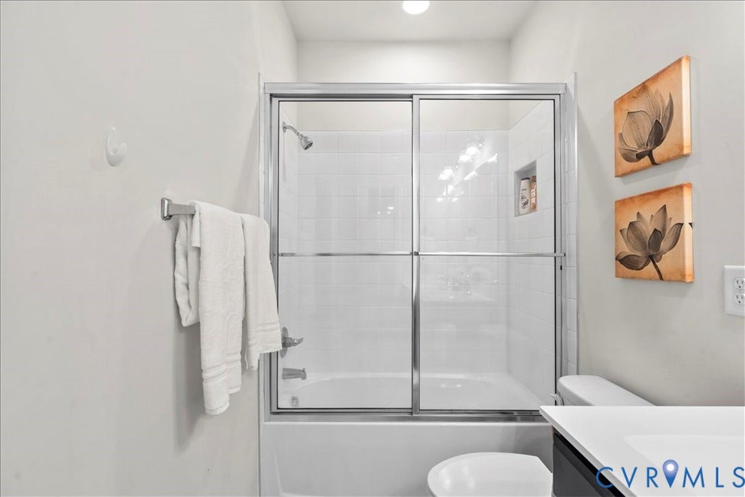 412 Quiet Breeze Alley, Chesterfield, VA 23113 Bathtub with subway tile surround, clear glass shower enclosure, and a built-in shower niche