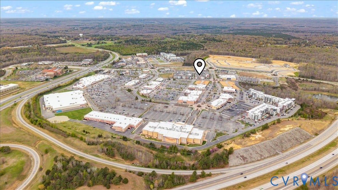 412 Quiet Breeze Alley, Chesterfield, VA 23113 Aerial perspective showcasing a mixed-use development with commercial buildings and multi-story residential structures