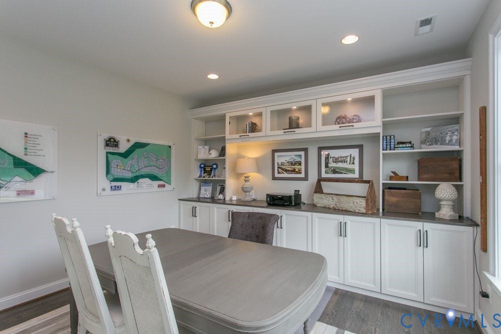 Built-in cabinetry with glass-front upper cabinets, open shelving, and lower storage