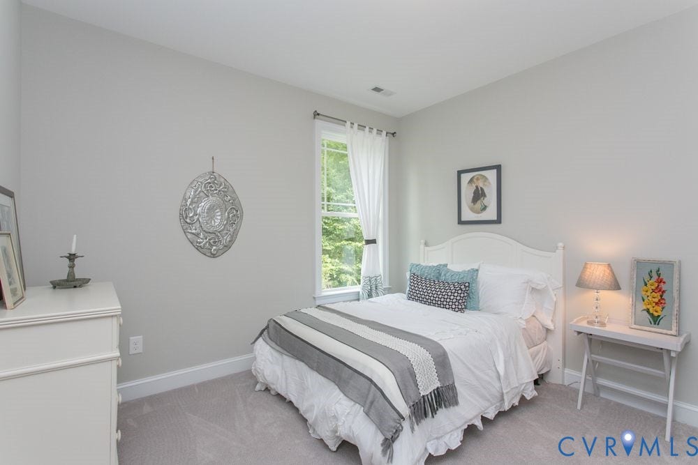 Recessed lighting, light gray wall color, white trim, and a window with white casing