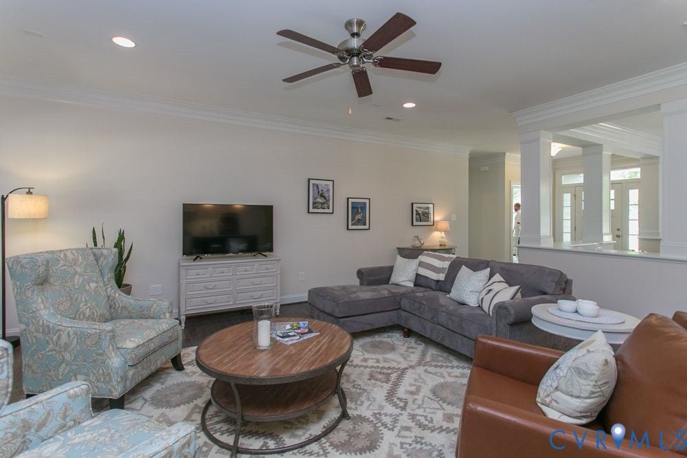 Recessed lighting, crown molding, wood-finish flooring, ceiling fan, and architectural half-wall with columns