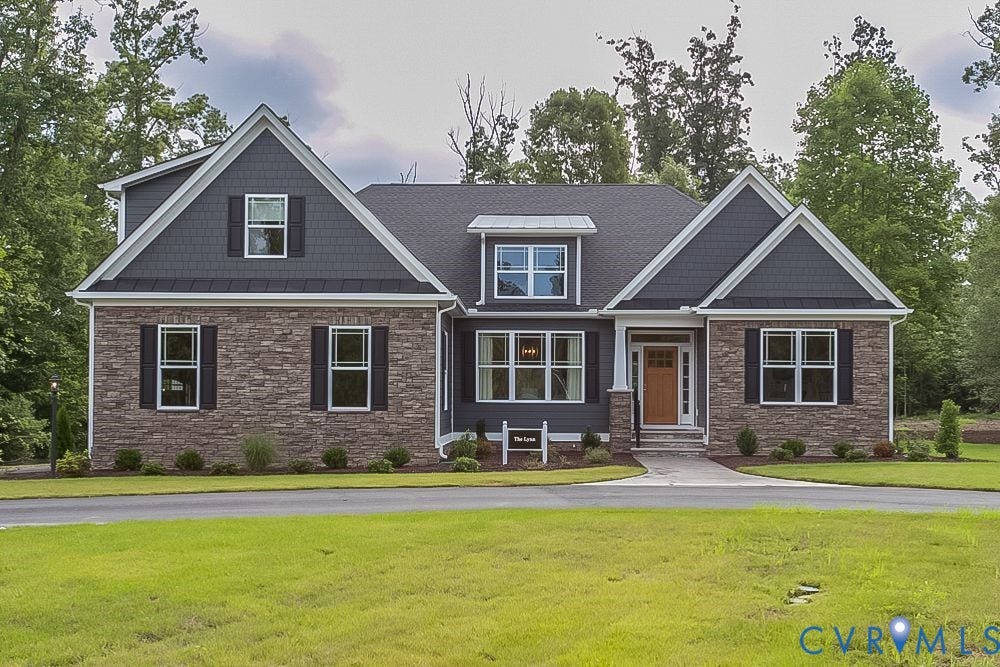 Stone veneer and horizontal siding exterior with shingle accents