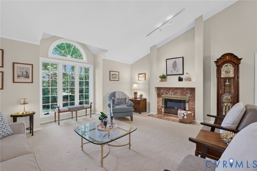 13001 River Hills Drive, Midlothian, VA 23113 A classic marble fireplace anchors the room, while Palladian-style windows bring in natural light and wooded views.