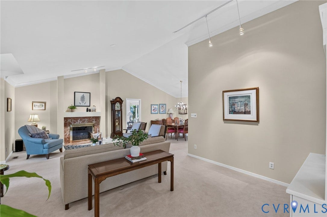 13001 River Hills Drive, Midlothian, VA 23113 Vaulted and cathedral ceilings give the living room an airy feel, complemented by a classic marble fireplace and abundant natural light.