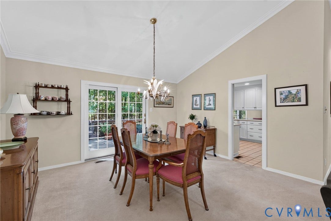 13001 River Hills Drive, Midlothian, VA 23113 Formal dining room with sliding French doors opening to the deck with wooded views beyond.