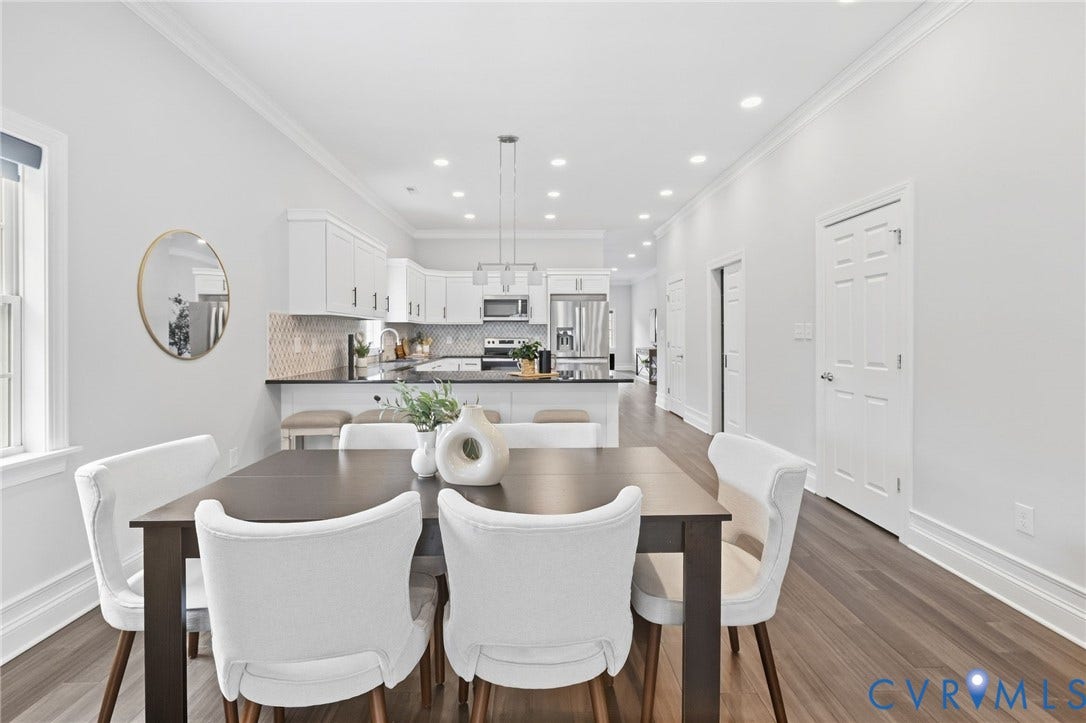 2002 Fairmount Avenue, Church Hill, Richmond, VA 23223 Open-concept living space with wood-finish flooring, recessed lighting, crown molding, and a kitchen featuring white cabinetry and stainless steel appliances