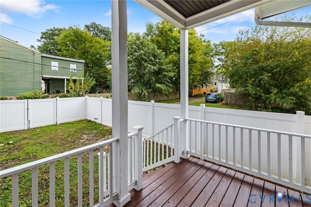 2002 Fairmount Avenue, Church Hill, Richmond, VA 23223 Covered porch with wood-finish decking, white railings, and a fenced yard