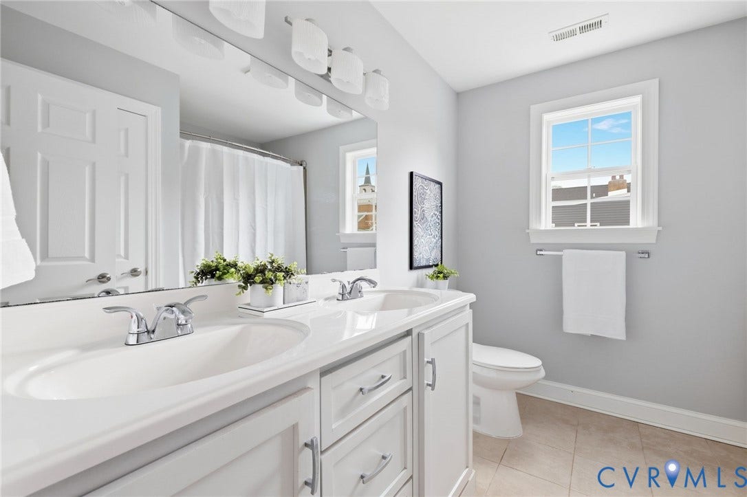 2002 Fairmount Avenue, Church Hill, Richmond, VA 23223 Dual vanity with integrated sinks, chrome faucets, and white cabinetry