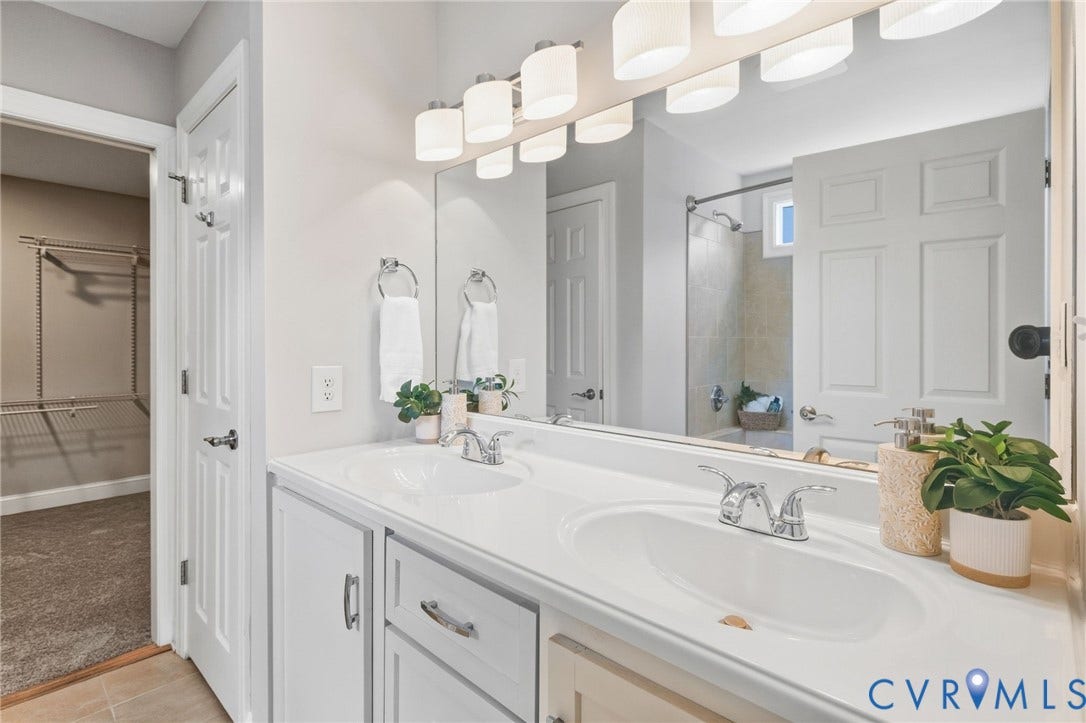 2002 Fairmount Avenue, Church Hill, Richmond, VA 23223 White dual vanity with integrated sinks, chrome faucets, and an expansive wall-mounted mirror