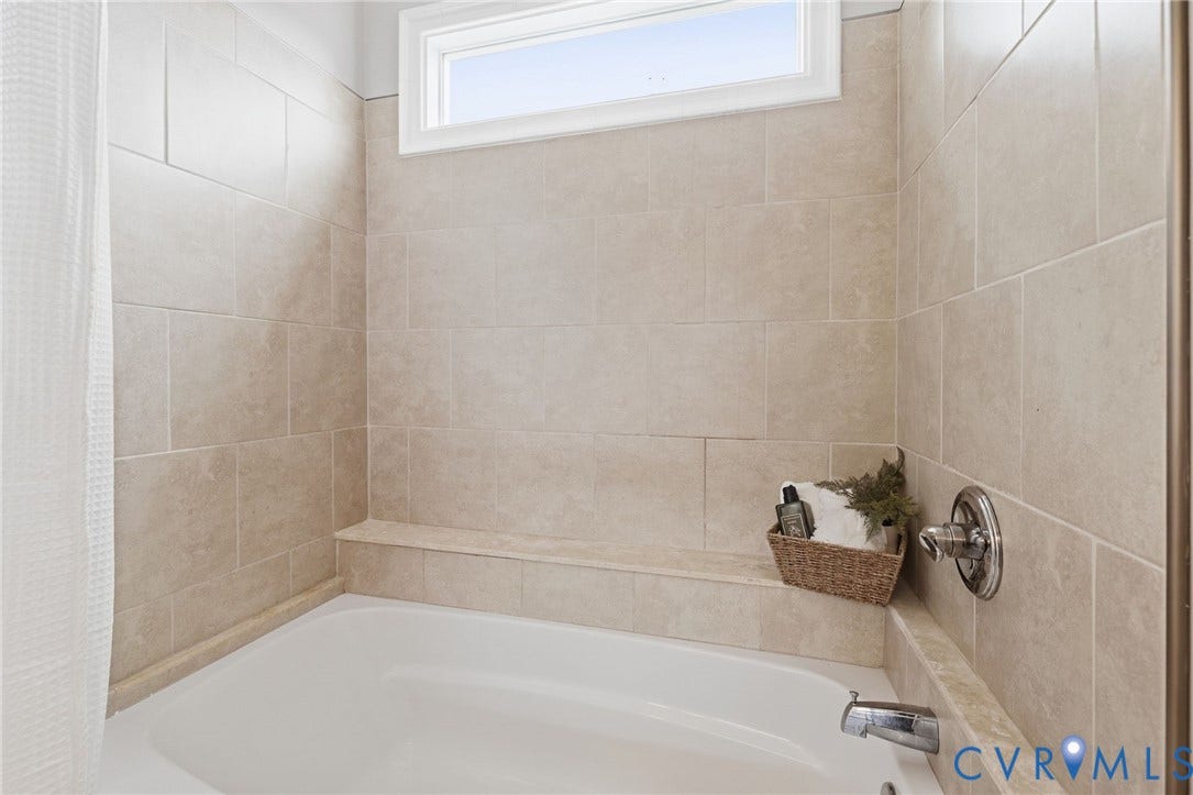 2002 Fairmount Avenue, Church Hill, Richmond, VA 23223 Bathtub with chrome fixtures, full-height tile surround, and an integrated tiled bench