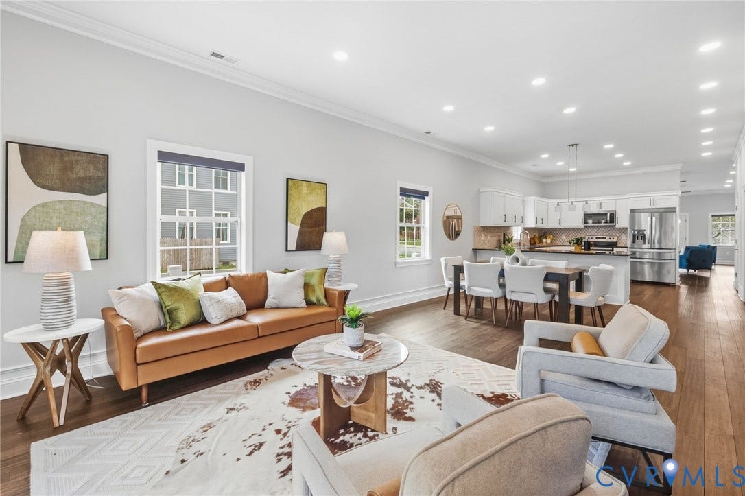 2002 Fairmount Avenue, Church Hill, Richmond, VA 23223 Open-concept living space featuring wood-finish flooring, recessed lighting, white crown molding, and a kitchen with white cabinetry and stainless steel appliances