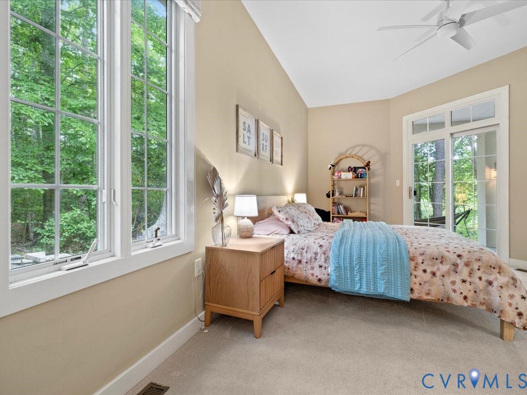 147 Oyster Cove Landing, Hartfield, VA 23071 Vaulted ceiling, ceiling fan, large grid-pattern windows, sliding glass door, and carpeted flooring