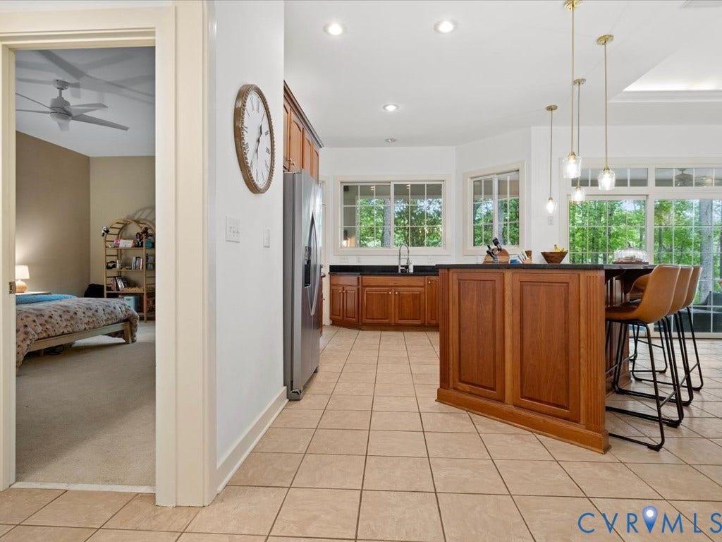 147 Oyster Cove Landing, Hartfield, VA 23071 Kitchen featuring wood cabinetry, stone countertops, stainless steel refrigerator, and tile flooring