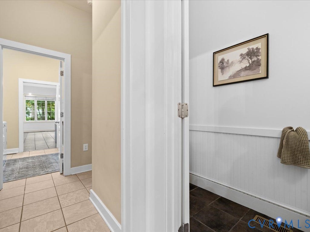 147 Oyster Cove Landing, Hartfield, VA 23071 Hard surface flooring throughout, white trim, and white paneled wainscoting