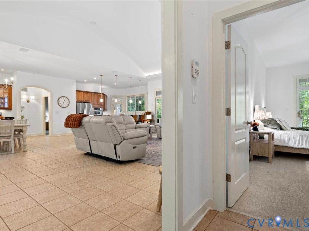147 Oyster Cove Landing, Hartfield, VA 23071 Open-concept living space with tile flooring, recessed lighting, and an arched doorway