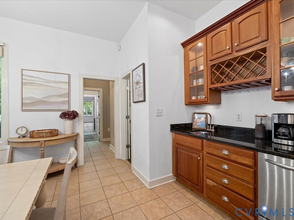 147 Oyster Cove Landing, Hartfield, VA 23071 Kitchenette featuring wood cabinetry, black countertop, a built-in sink, and stainless steel appliance