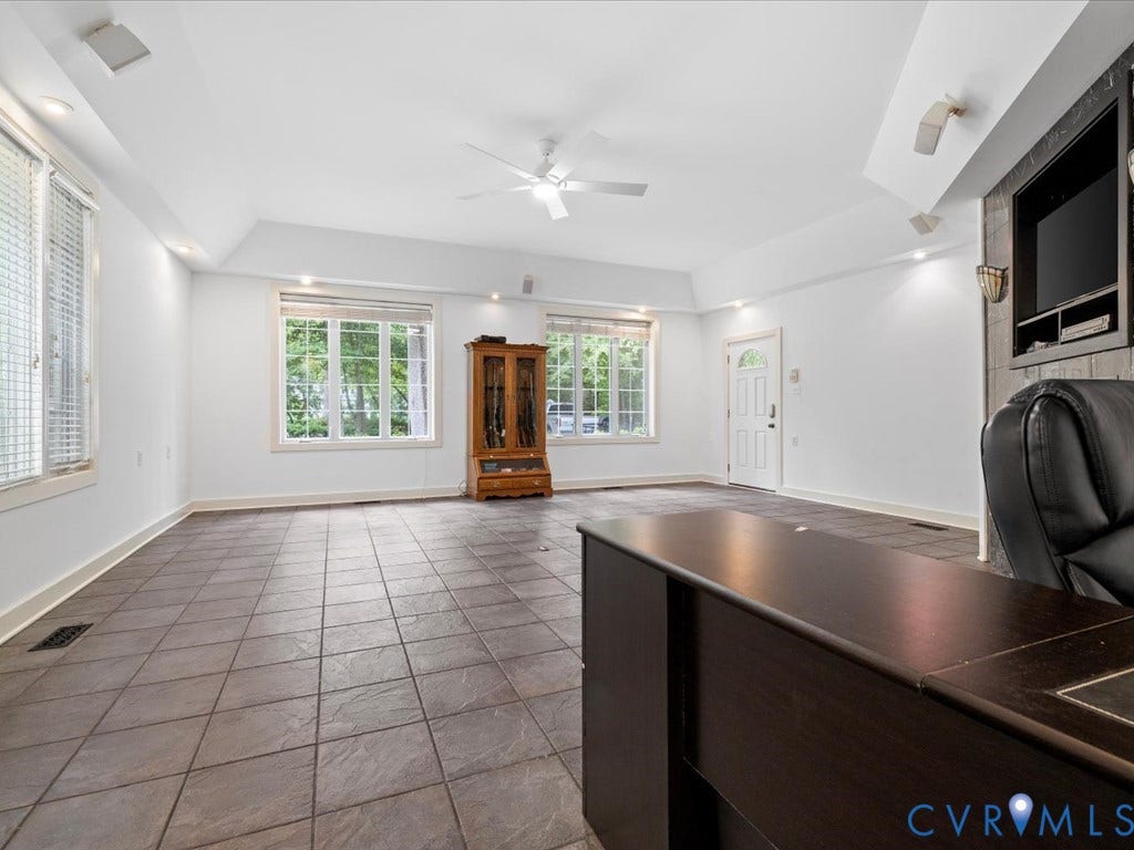 147 Oyster Cove Landing, Hartfield, VA 23071 Spacious room featuring neutral tile flooring, multiple windows, a ceiling fan, recessed lighting, and a built-in media center
