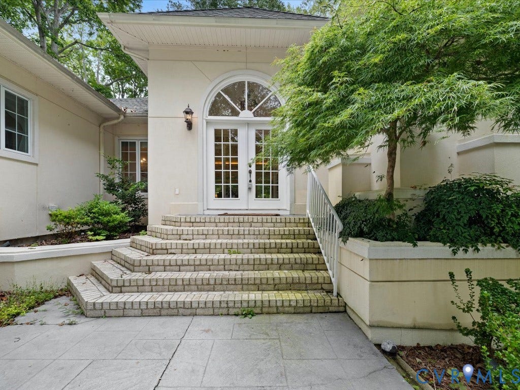 147 Oyster Cove Landing, Hartfield, VA 23071 Arched double doors and transom window, brick steps with metal railing, and a mature ornamental tree