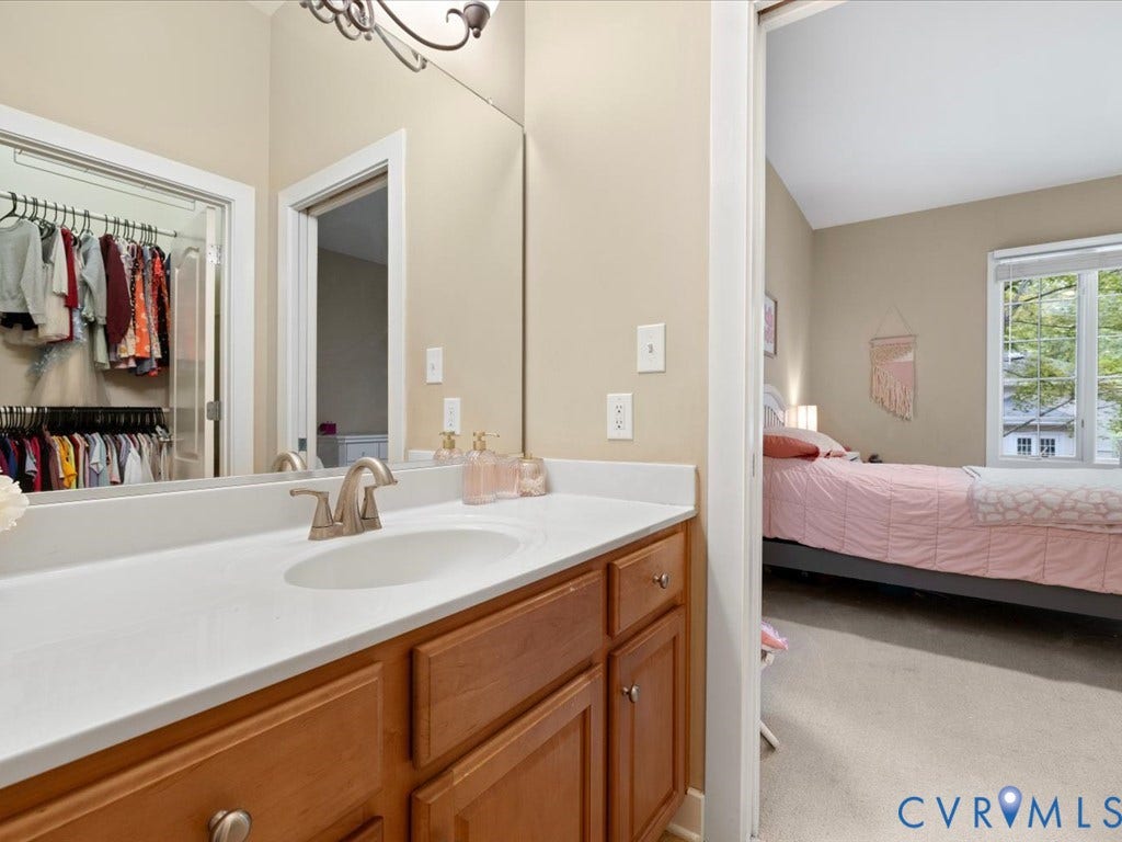 147 Oyster Cove Landing, Hartfield, VA 23071 Bathroom vanity with a white countertop, undermount sink, and brushed nickel faucet