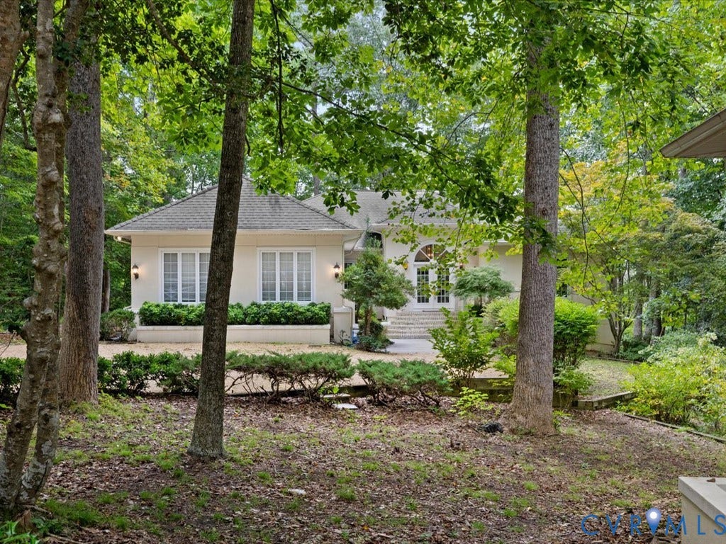 147 Oyster Cove Landing, Hartfield, VA 23071 Stucco exterior with multiple windows, arched double doors, and a tiled roof