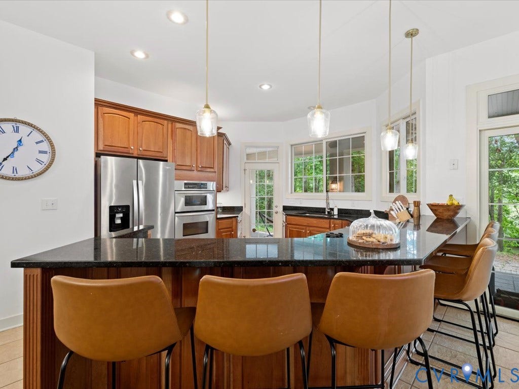 147 Oyster Cove Landing, Hartfield, VA 23071 Kitchen with a dark-toned island, wood cabinetry, stainless steel appliances, and recessed lighting
