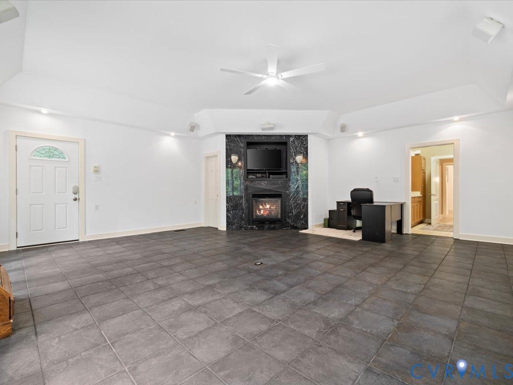 147 Oyster Cove Landing, Hartfield, VA 23071 Recessed lighting, ceiling fan, fireplace with a dark stone surround, and tile flooring