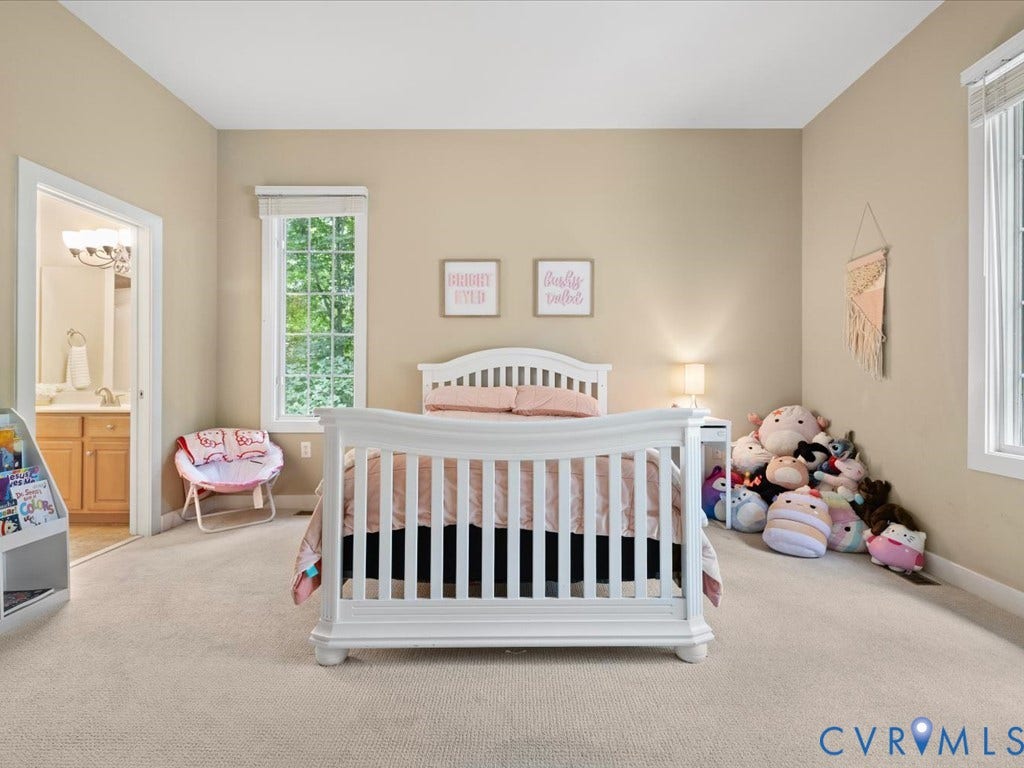 147 Oyster Cove Landing, Hartfield, VA 23071 Recessed lighting, light neutral wall paint, two large windows, white window trim, and light beige carpet