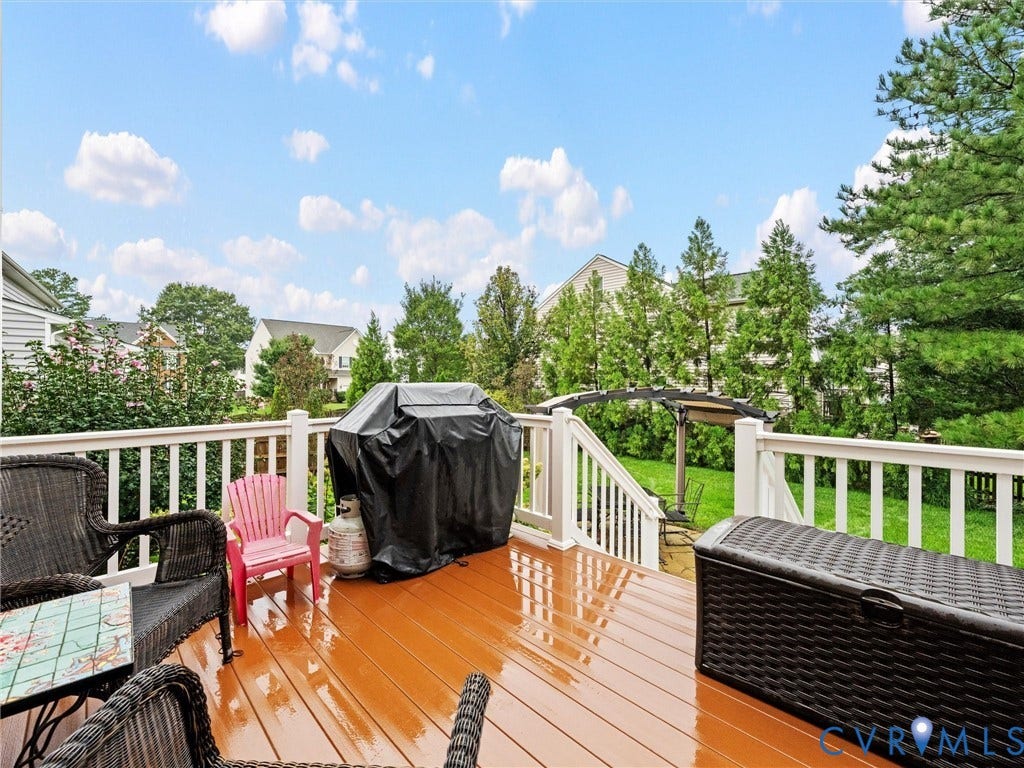 9990 Orchard Meadow Road, Mechanicsville, VA 23116 Expansive rear deck with wood-finish surface, white railings, and integrated stairs to a manicured lawn