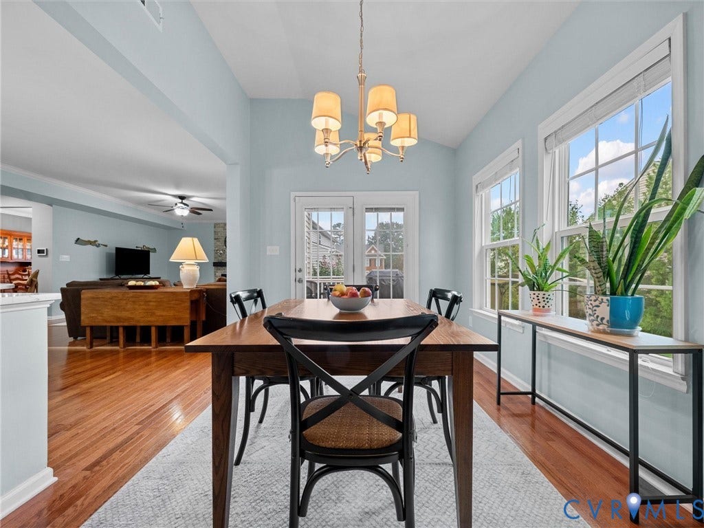 9990 Orchard Meadow Road, Mechanicsville, VA 23116 Vaulted ceiling with chandelier, French door, and two large windows with white trim