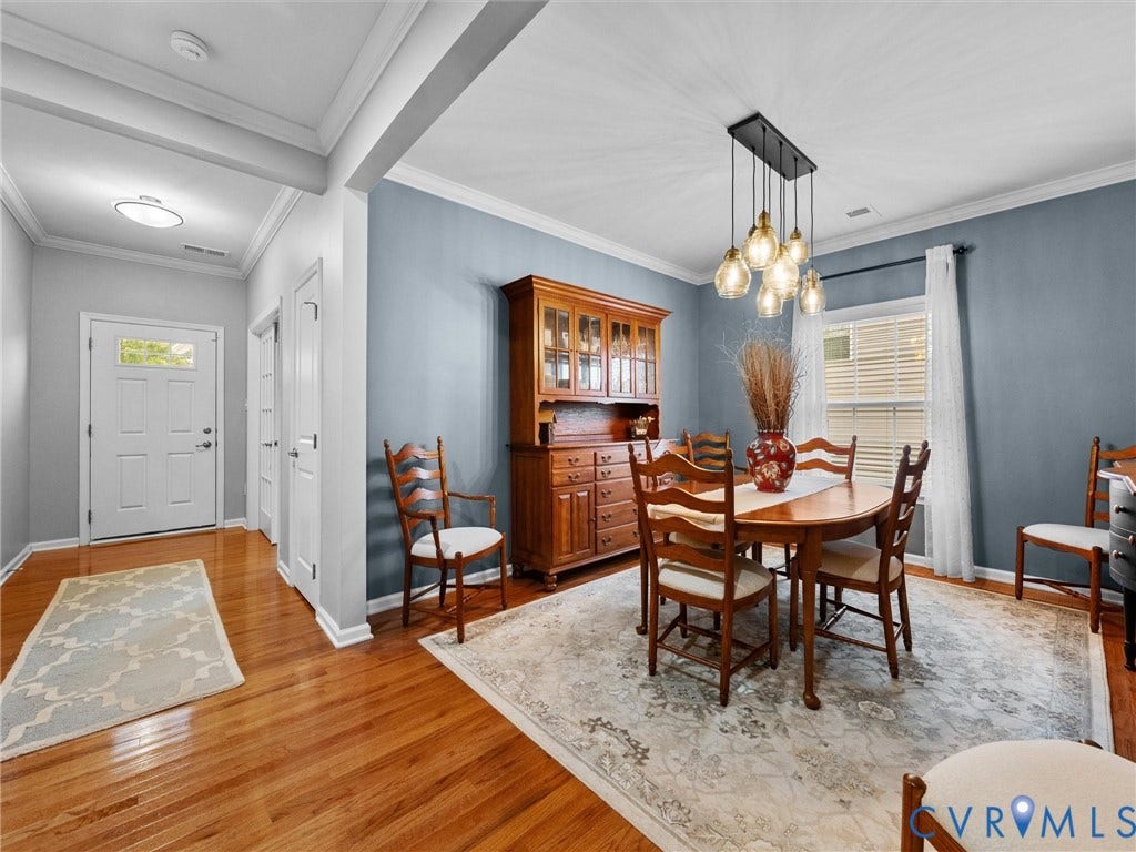 9990 Orchard Meadow Road, Mechanicsville, VA 23116 Hardwood flooring, crown molding, modern chandelier, and a transom window at the entry