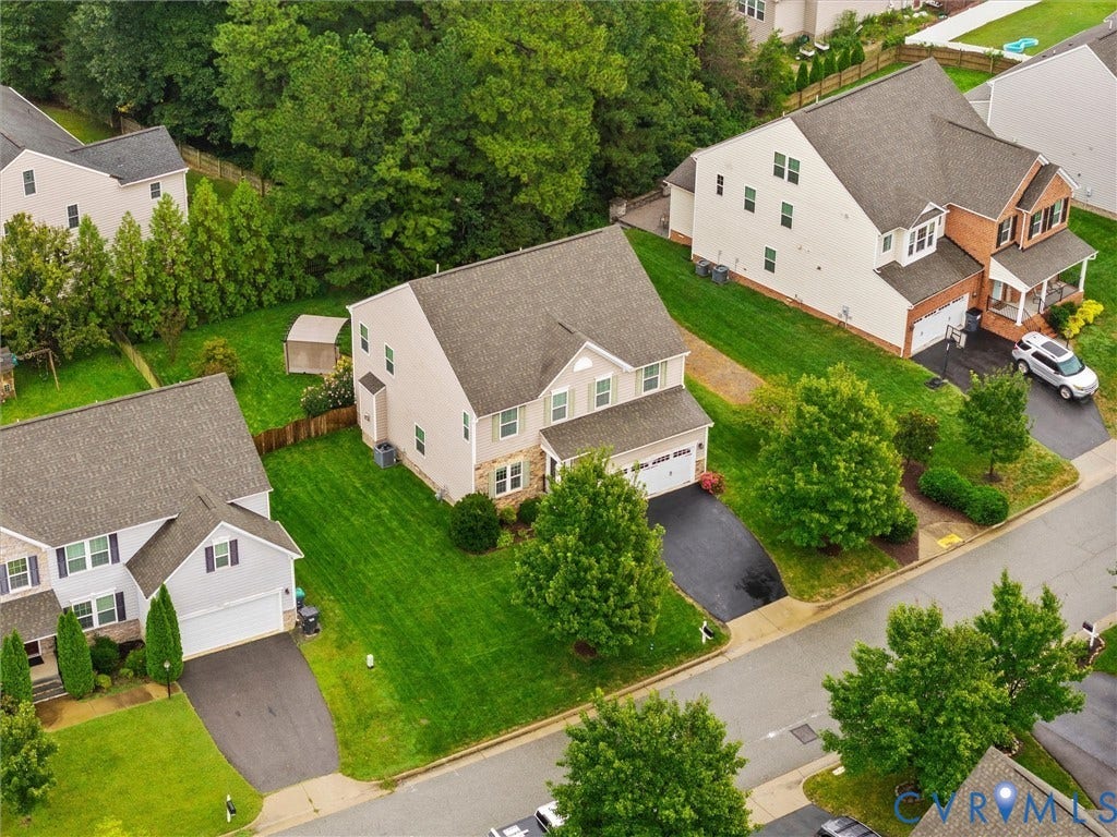 9990 Orchard Meadow Road, Mechanicsville, VA 23116 Two-story residence with a two-car garage, featuring a gray shingle roof and light-colored siding