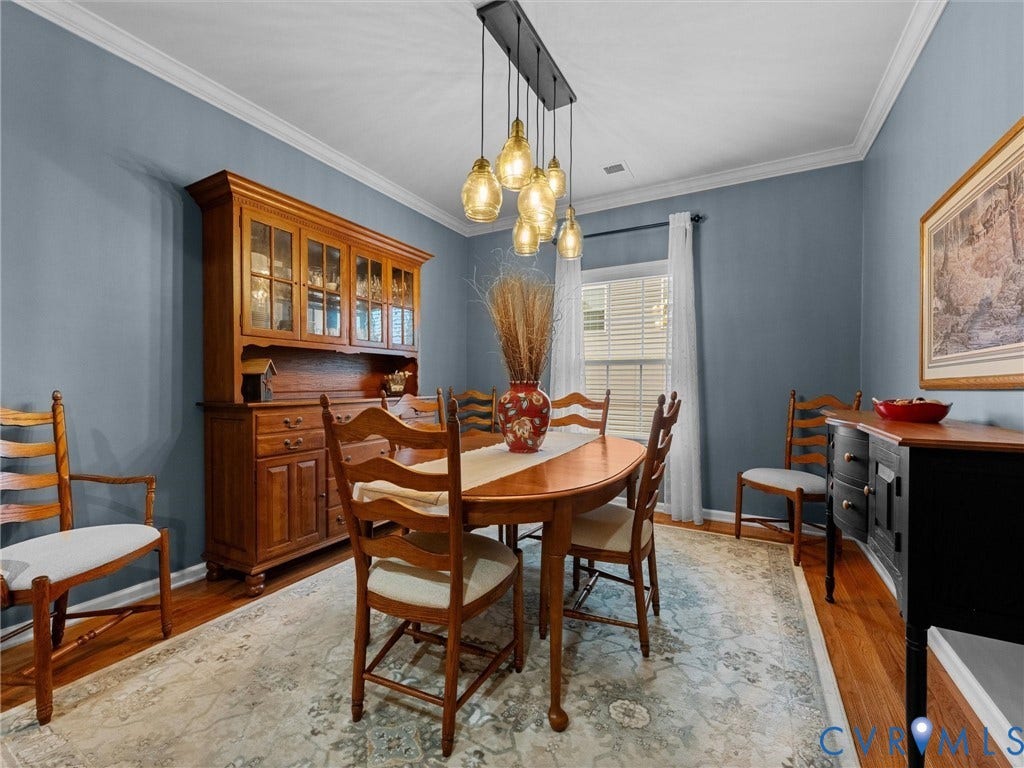 9990 Orchard Meadow Road, Mechanicsville, VA 23116 Hardwood flooring, crown molding, a built-in chandelier, and abundant natural light from a window