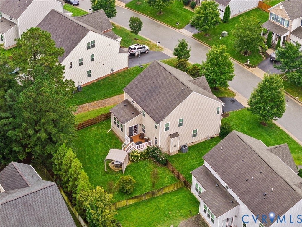 9990 Orchard Meadow Road, Mechanicsville, VA 23116 Expansive backyard featuring a manicured lawn, established trees, and a multi-level deck with white railings