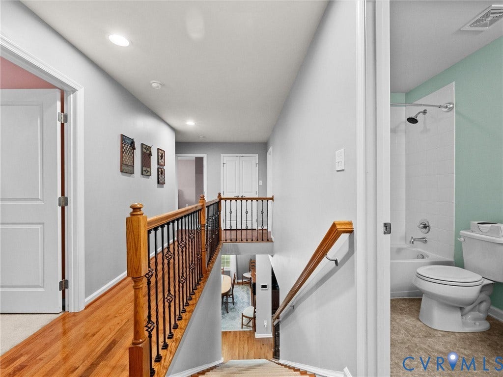 9990 Orchard Meadow Road, Mechanicsville, VA 23116 Recessed lighting, wood-finish flooring, staircase with wrought iron balusters, and a full bathroom with a tub/shower combination