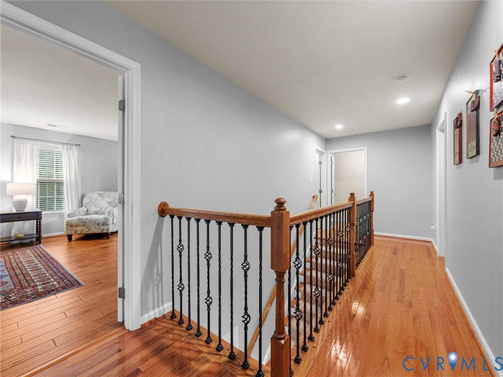 9990 Orchard Meadow Road, Mechanicsville, VA 23116 Hardwood flooring throughout, with a wood and wrought iron staircase railing
