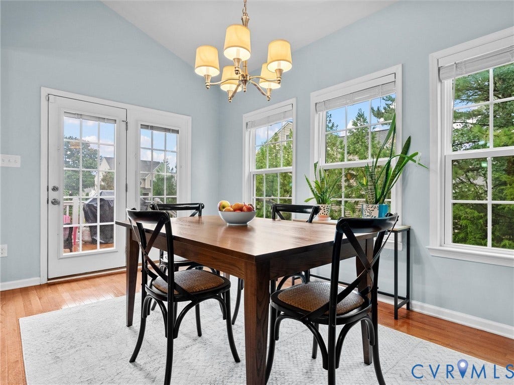 9990 Orchard Meadow Road, Mechanicsville, VA 23116 Hardwood-finish flooring, vaulted ceiling, multiple windows, and a chandelier fixture
