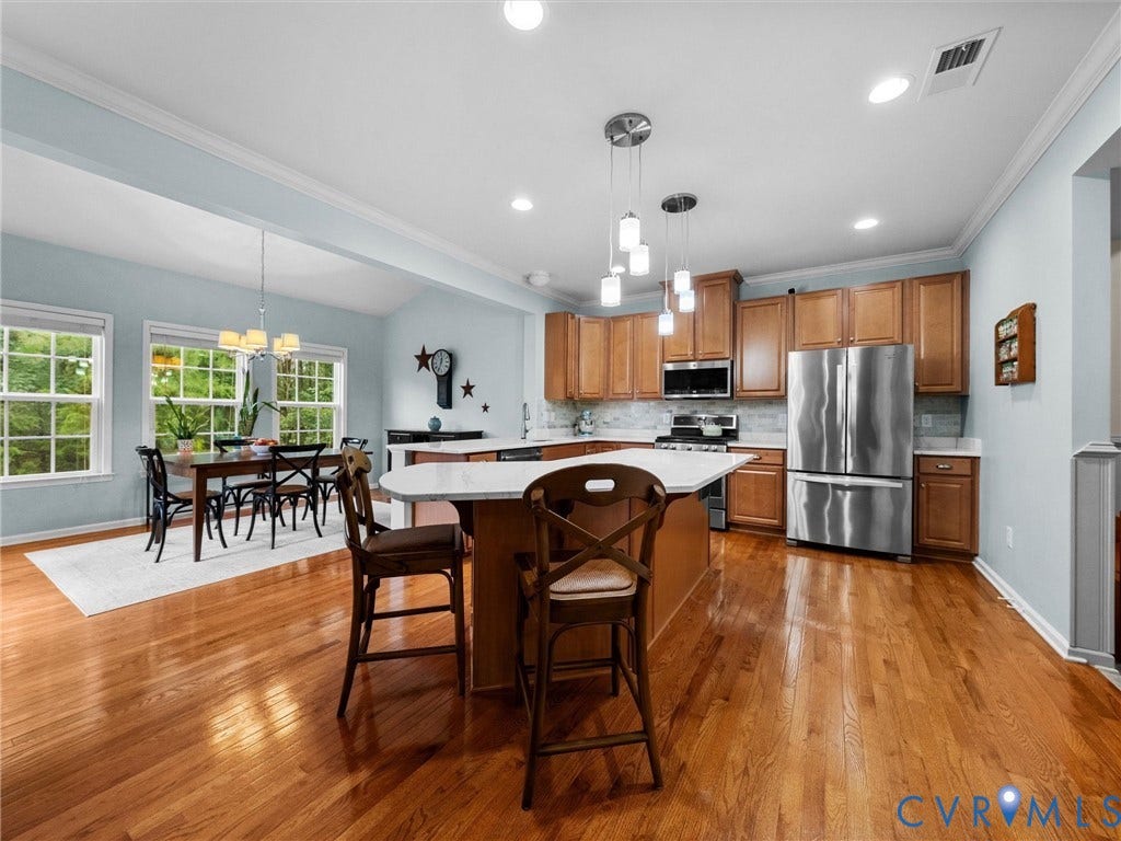 9990 Orchard Meadow Road, Mechanicsville, VA 23116 Kitchen featuring wood cabinetry, stainless steel appliances, and a central island with a white countertop